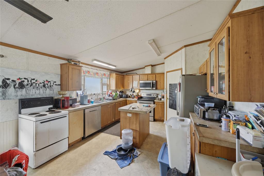 2449 East Fm 120 Denison, TX 75021 - Photo 22 of 30 a kitchen with a sink appliances and cabinets