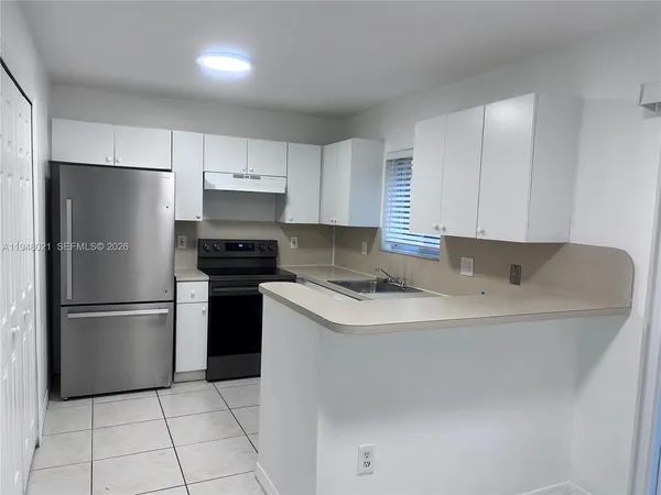 a kitchen with a sink cabinets and appliances