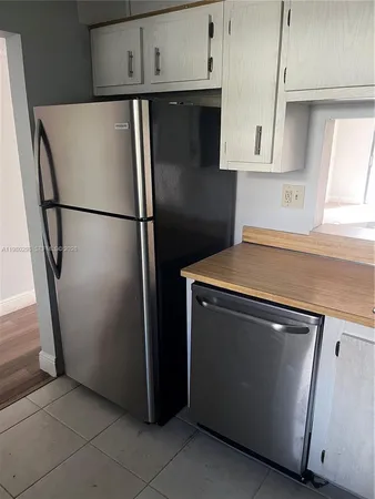 a white refrigerator freezer sitting in a kitchen