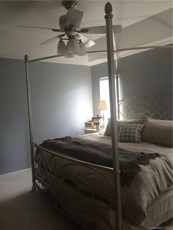 1037 Ridgefield Circle Indian Trail, NC 28079 - Photo 12 of 19 a bedroom with a bed and a chandelier