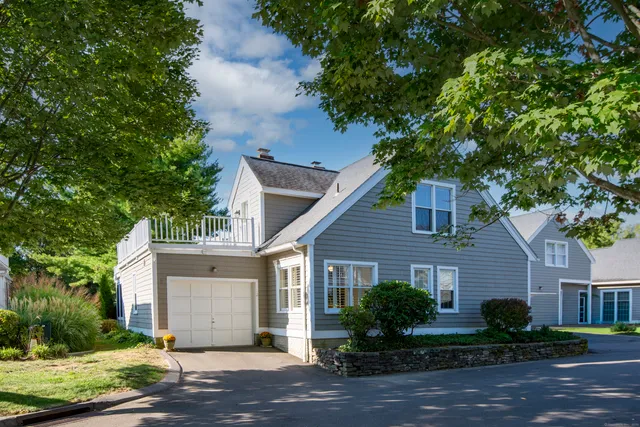 a front view of a house with a yard and a garage