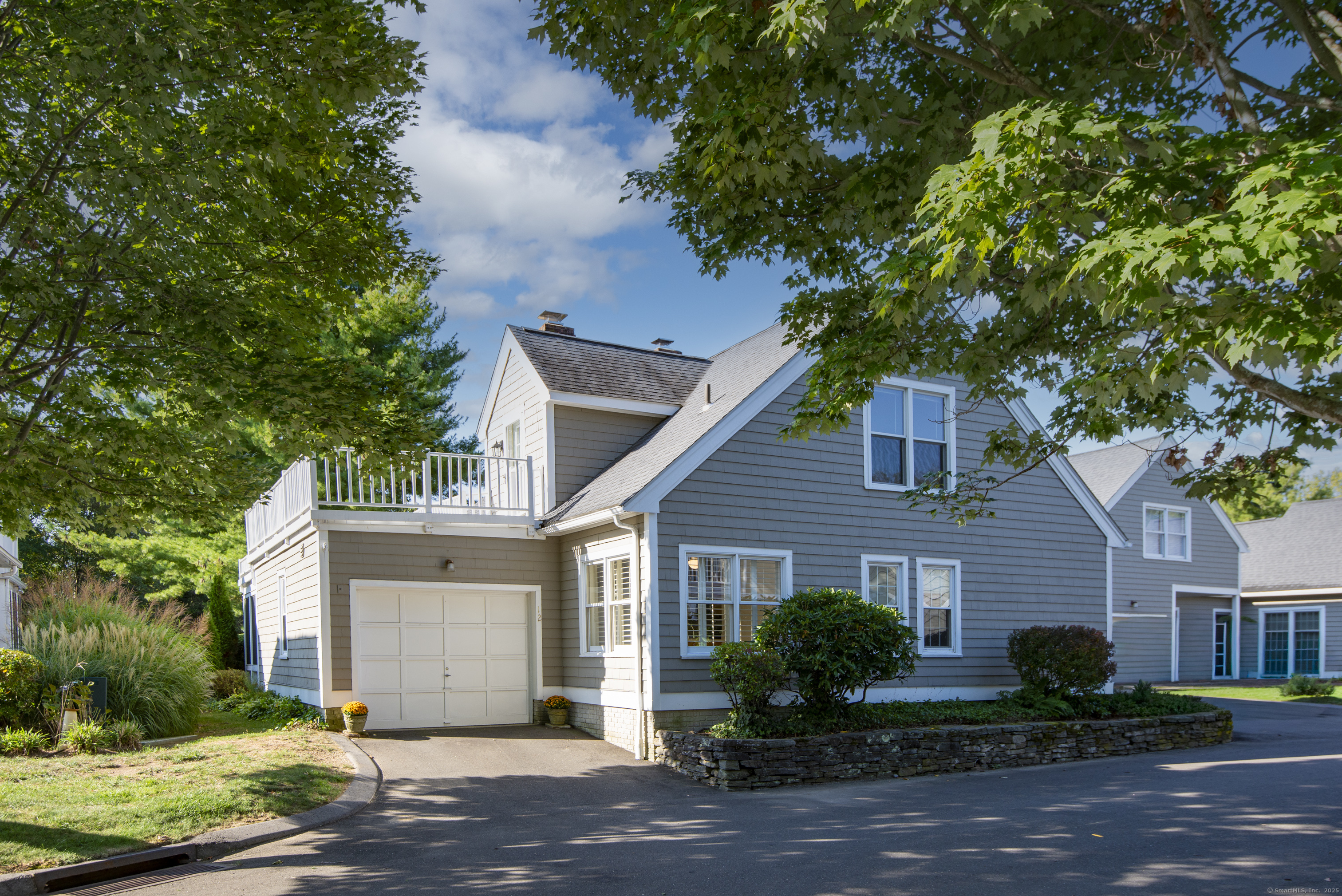 a front view of a house with a yard and a garage
