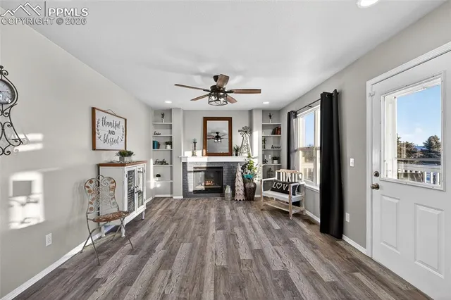 a living room with furniture a fireplace and a flat screen tv