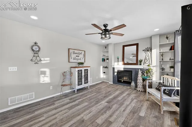 a view of a kitchen with kitchen island stainless steel appliances wooden floor dining table and chairs