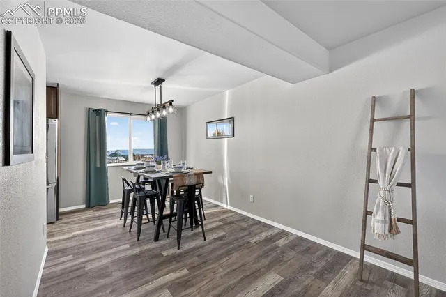a view of a dining room with furniture and window