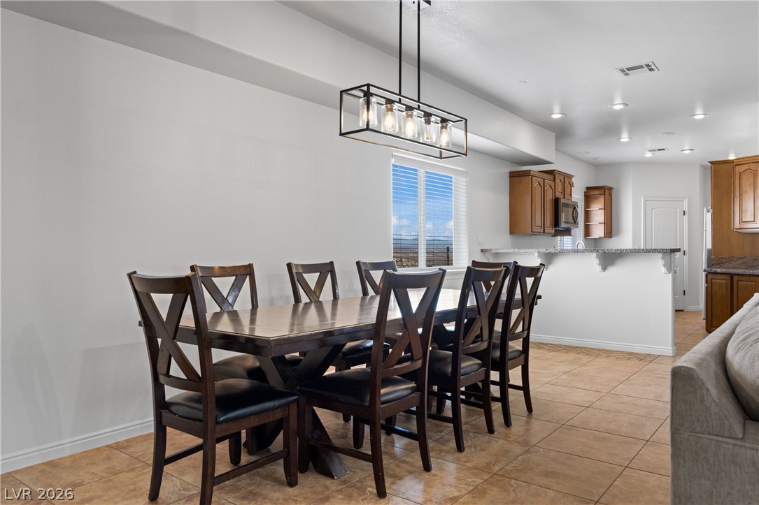 575 Gann Avenue Logandale, NV 89021 - Photo 15 of 75 A well-appointed dining space flows into the kitchen, ideal for entertaining.