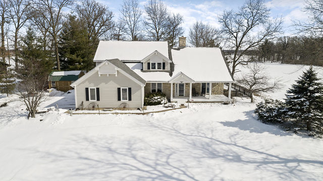 8N261 Thomas Road Maple Park, IL 60151 - Photo 2 of 36 a view of a white house with a yard covered in snow
