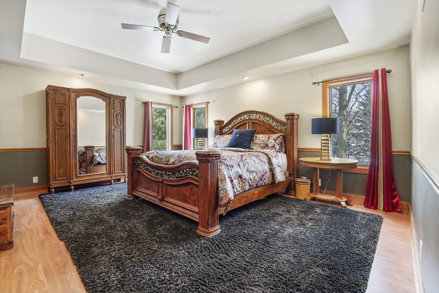 8N261 Thomas Road Maple Park, IL 60151 - Photo 17 of 36 a bed room with a bed and a chandelier