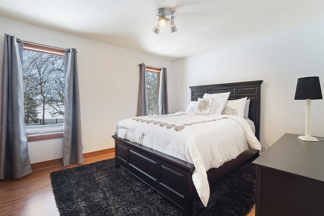8N261 Thomas Road Maple Park, IL 60151 - Photo 19 of 36 a bedroom with a bed and wooden floor