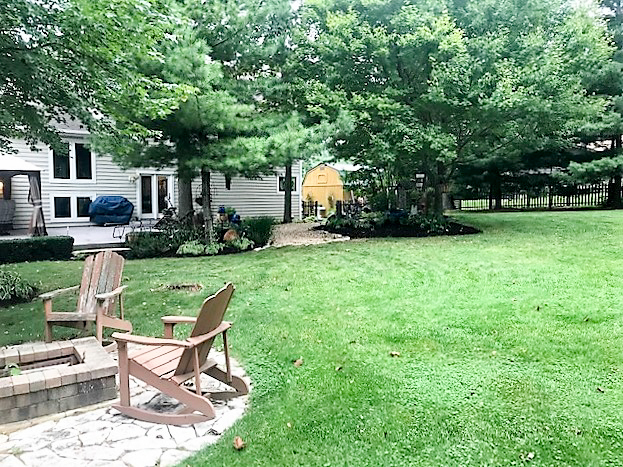 8N261 Thomas Road Maple Park, IL 60151 - Photo 30 of 36 a view of a backyard with table and chairs potted plants and large tree