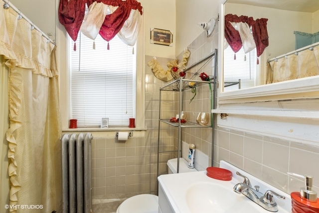 Undisclosed Address Chicago, IL 60619 - Photo 7 of 12 a bathroom with a sink mirror and toilet