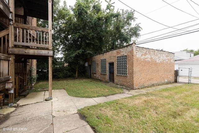 Undisclosed Address Chicago, IL 60619 - Photo 9 of 12 a view of a house with a yard