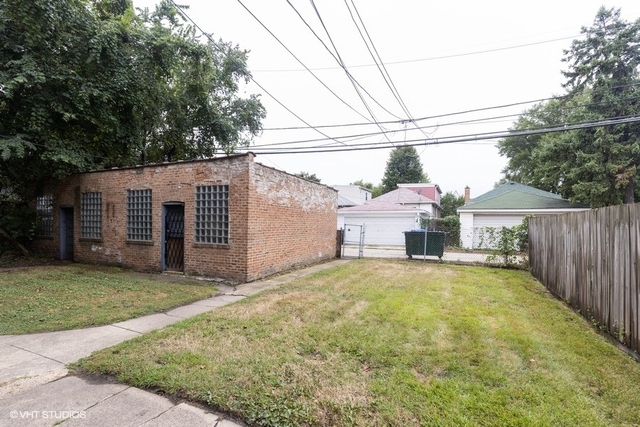 Undisclosed Address Chicago, IL 60619 - Photo 10 of 12 a front view of a house with a garden