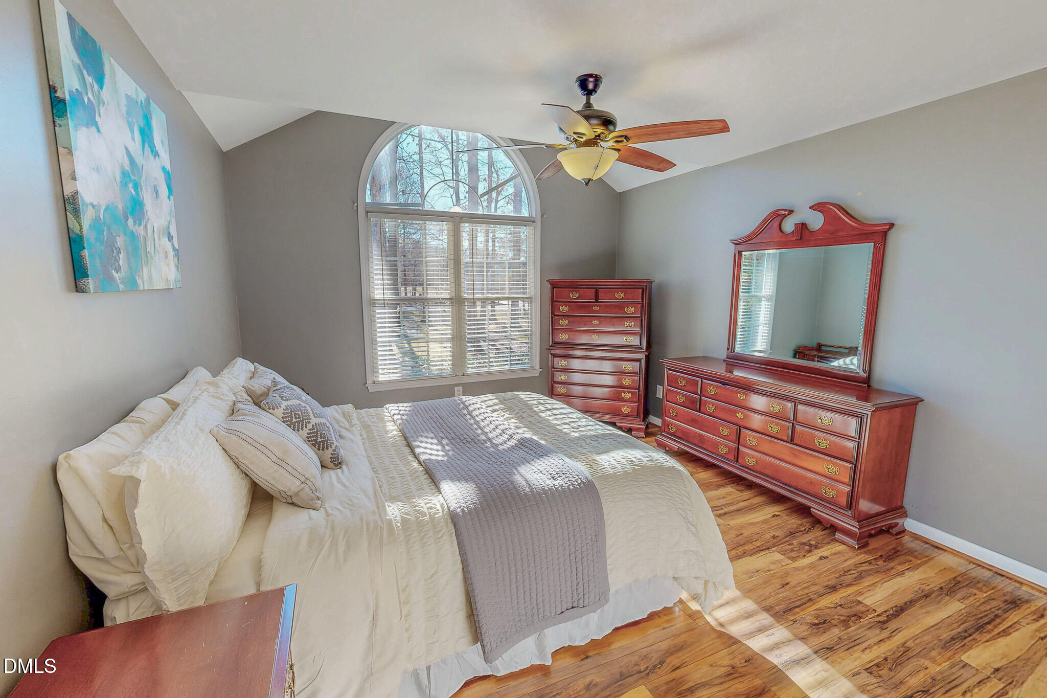60 Forest Drive Timberlake, NC 27583 - Photo 11 of 40 a bedroom with a bed and a chandelier
