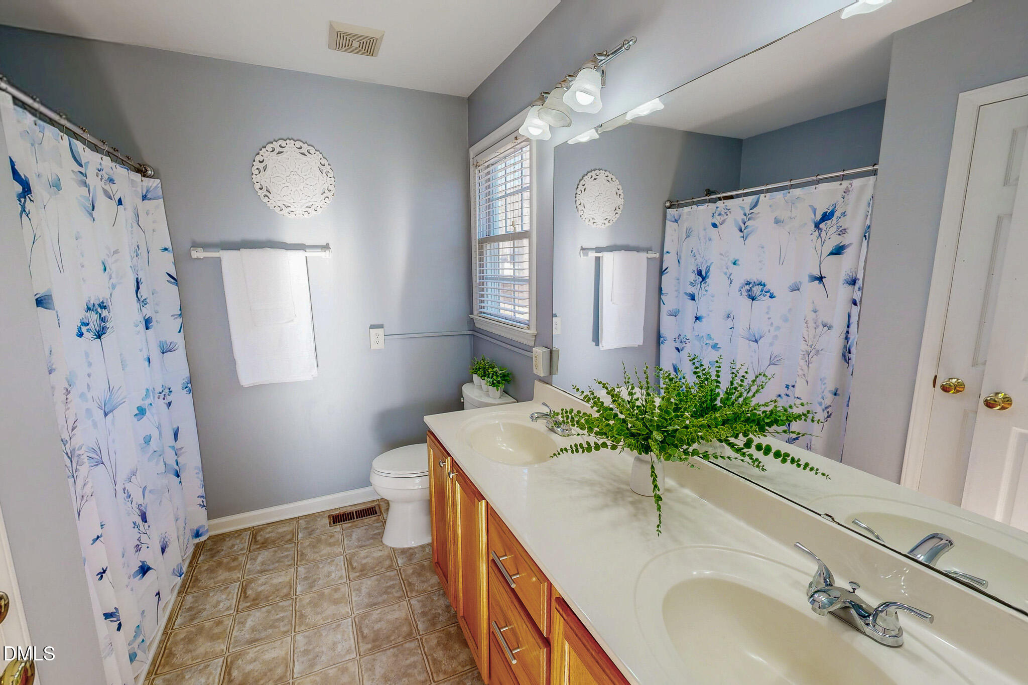 60 Forest Drive Timberlake, NC 27583 - Photo 12 of 40 a bathroom with a granite countertop sink a mirror a vanity and a shower