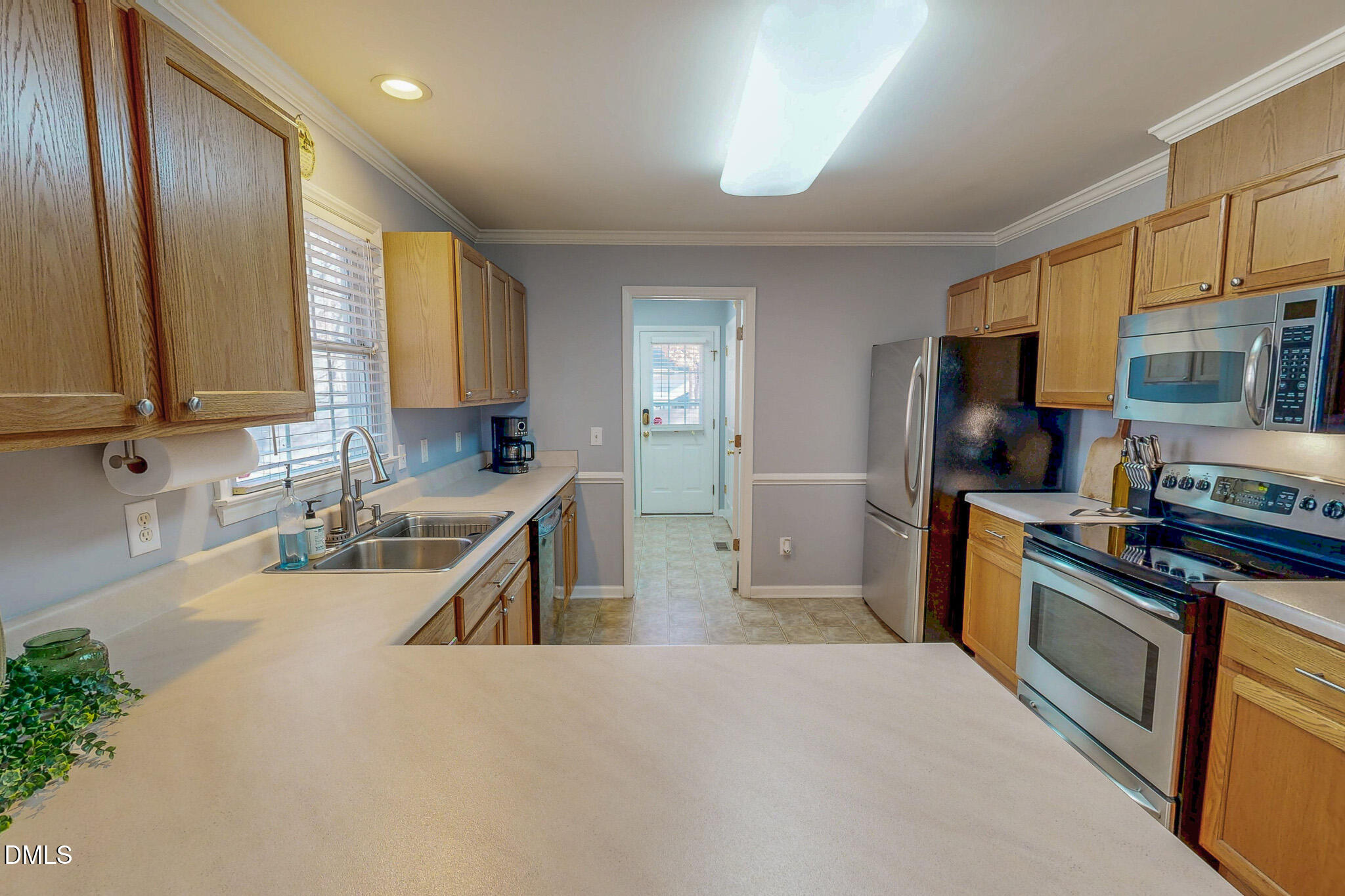 60 Forest Drive Timberlake, NC 27583 - Photo 20 of 40 a kitchen with stainless steel appliances granite countertop a sink stove and refrigerator