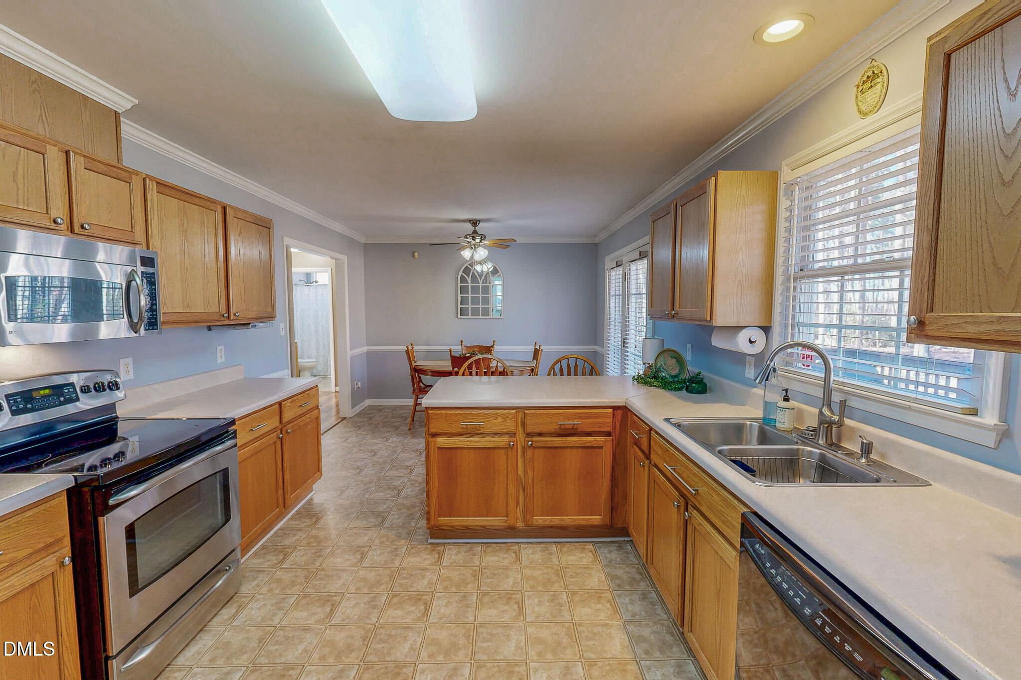 60 Forest Drive Timberlake, NC 27583 - Photo 25 of 40 a large kitchen with stainless steel appliances granite countertop a sink and a stove