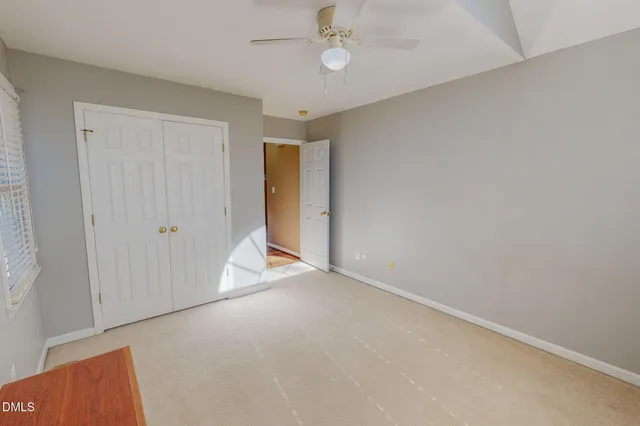 an empty room with a ceiling fan