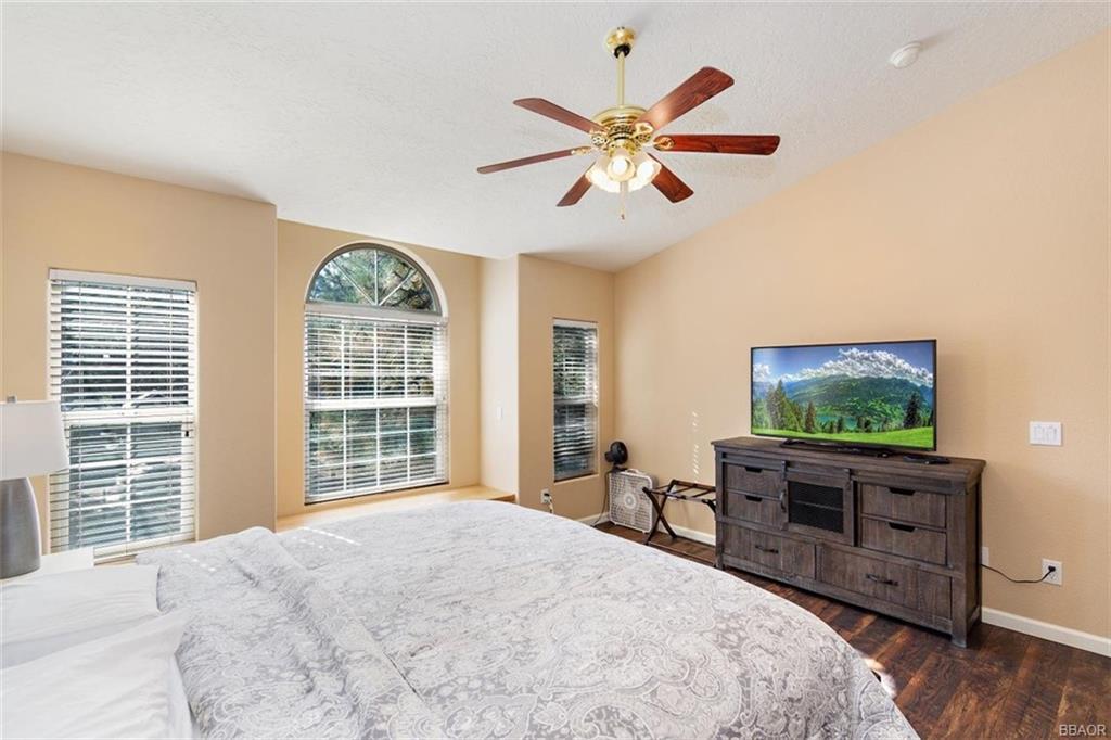 613 Riverside Avenue Sugarloaf, CA 92386 - Photo 13 of 27 a bedroom with a bed and a flat screen tv