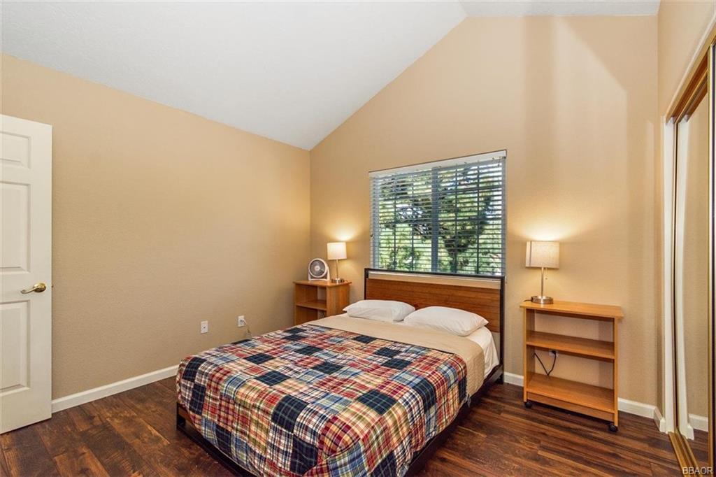 613 Riverside Avenue Sugarloaf, CA 92386 - Photo 16 of 27 a bedroom with a bed and a window