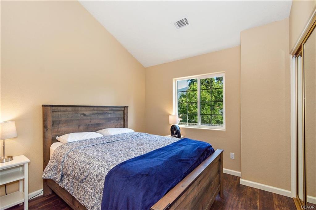 613 Riverside Avenue Sugarloaf, CA 92386 - Photo 18 of 27 a bedroom with a bed and a window