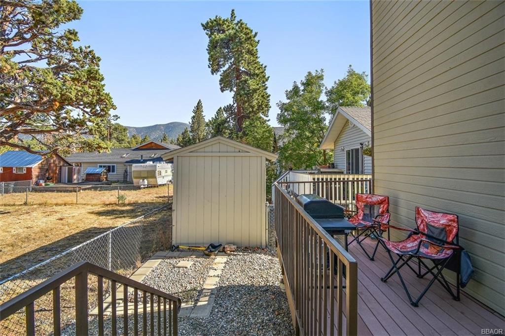 613 Riverside Avenue Sugarloaf, CA 92386 - Photo 21 of 27 a balcony with wooden floor and outdoor seating