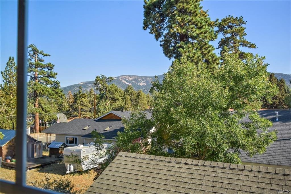 613 Riverside Avenue Sugarloaf, CA 92386 - Photo 23 of 27 a view of a chairs and table in the patio next to a yard