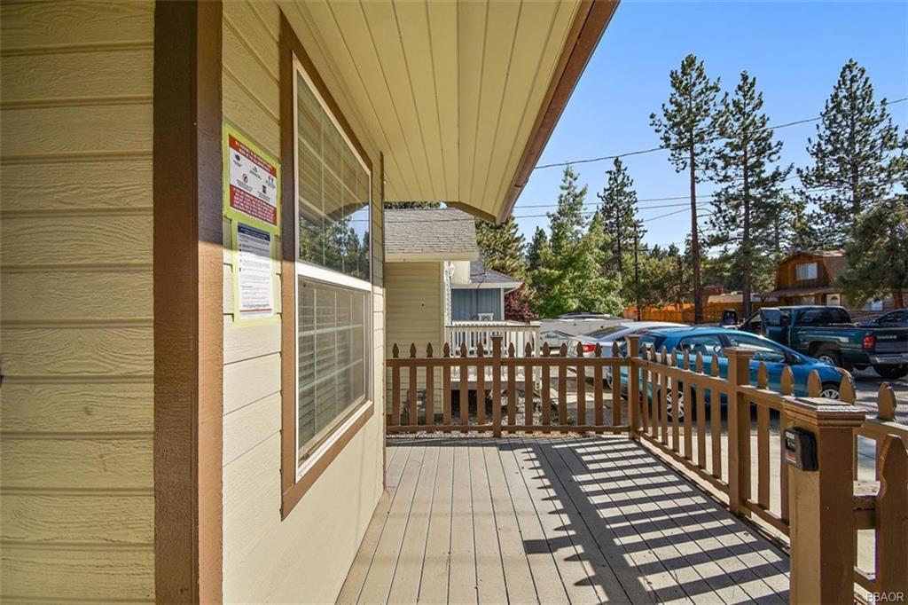 613 Riverside Avenue Sugarloaf, CA 92386 - Photo 24 of 27 a view of a balcony with wooden floor and iron fence
