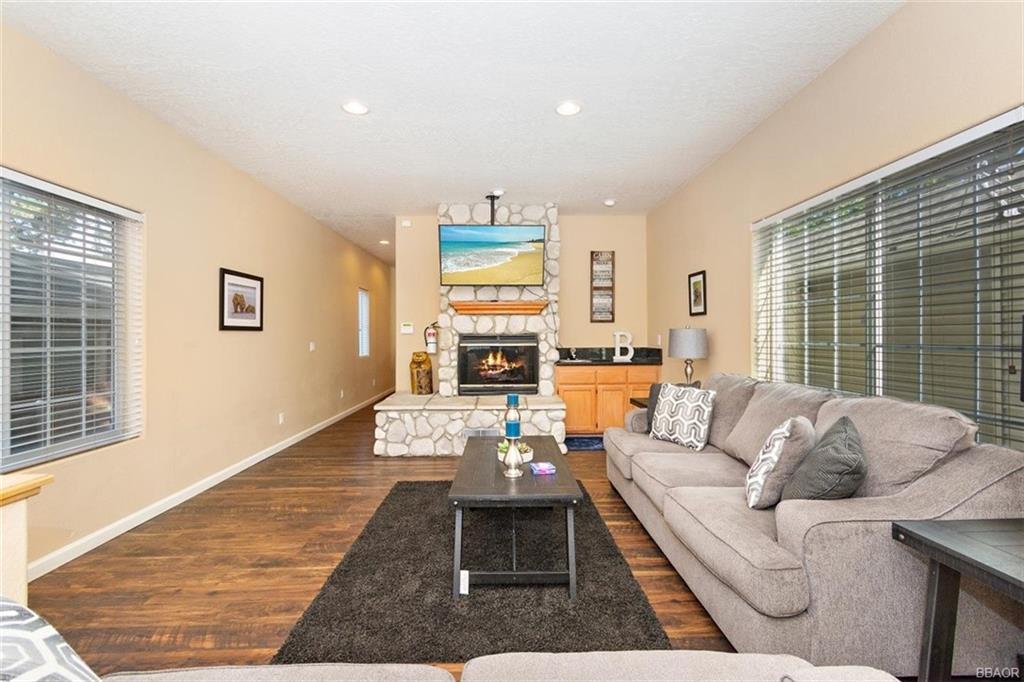 613 Riverside Avenue Sugarloaf, CA 92386 - Photo 4 of 27 a living room with furniture fireplace and a large window