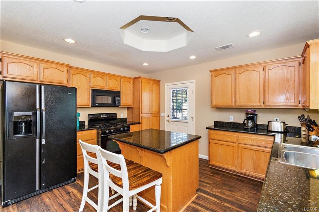 613 Riverside Avenue Sugarloaf, CA 92386 - Photo 7 of 27 a kitchen with granite countertop a sink stainless steel appliances and cabinets