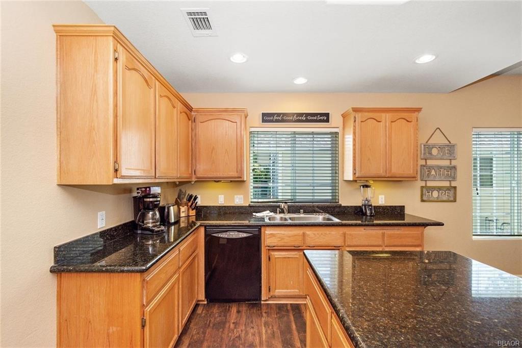 613 Riverside Avenue Sugarloaf, CA 92386 - Photo 9 of 27 a kitchen with granite countertop a sink a counter top space and cabinets