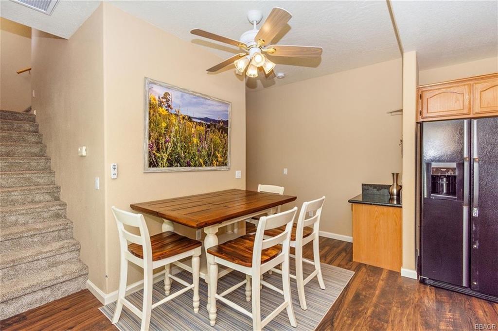 613 Riverside Avenue Sugarloaf, CA 92386 - Photo 10 of 27 a view of a dining room with furniture and wooden floor