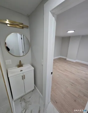 a bathroom with a sink a mirror and vanity