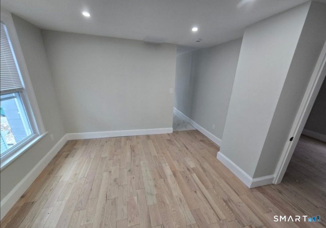 80 Dickerman Street New Haven, CT 06511 - Photo 7 of 12 wooden floor in an empty room with a window