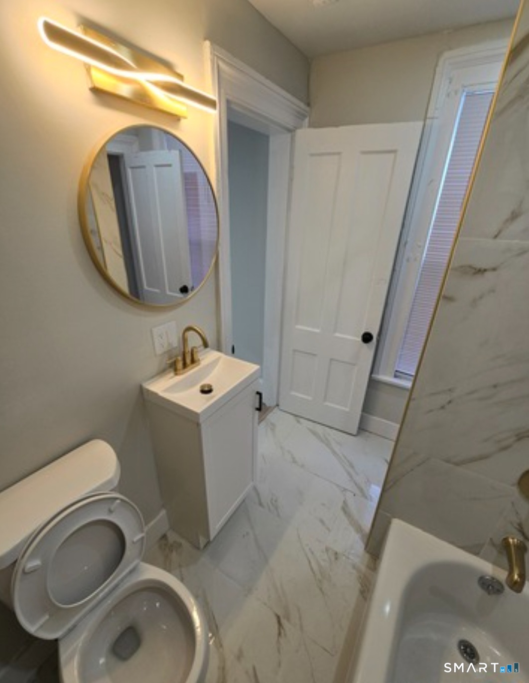 80 Dickerman Street New Haven, CT 06511 - Photo 9 of 12 a bathroom with a sink mirror and toilet