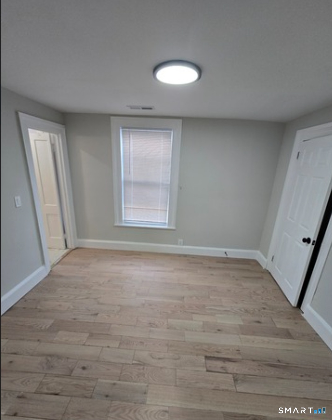 80 Dickerman Street New Haven, CT 06511 - Photo 10 of 12 a view of empty room with wooden floor and fan
