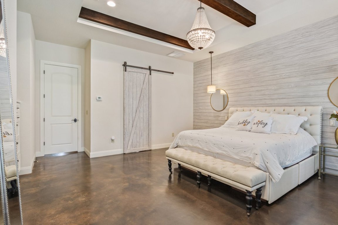 320 Ridge View Drive Georgetown, TX 78628 - Photo 11 of 31 a bedroom with a bed and a chandelier