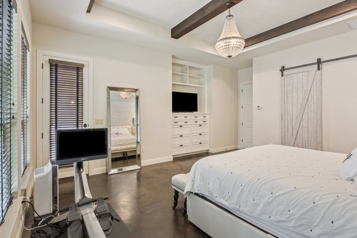 320 Ridge View Drive Georgetown, TX 78628 - Photo 12 of 31 a bedroom with a bed and a flat screen tv