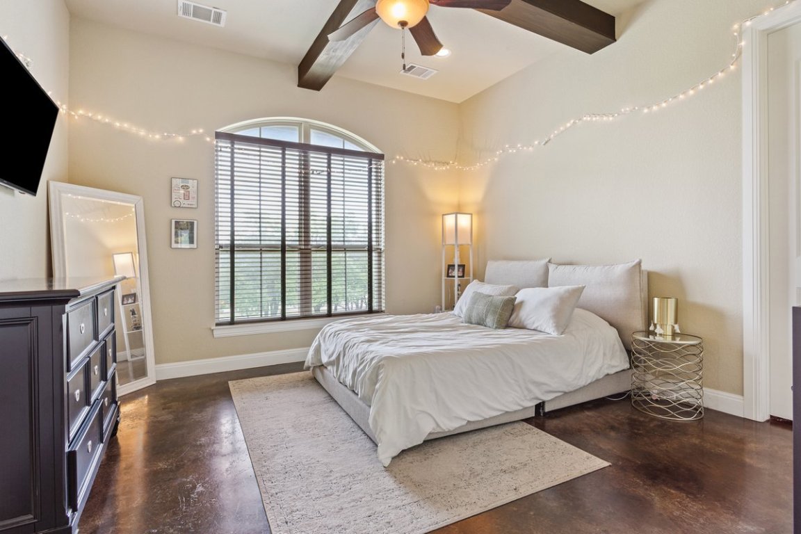 320 Ridge View Drive Georgetown, TX 78628 - Photo 13 of 31 a bedroom with a large bed and a chandelier fan