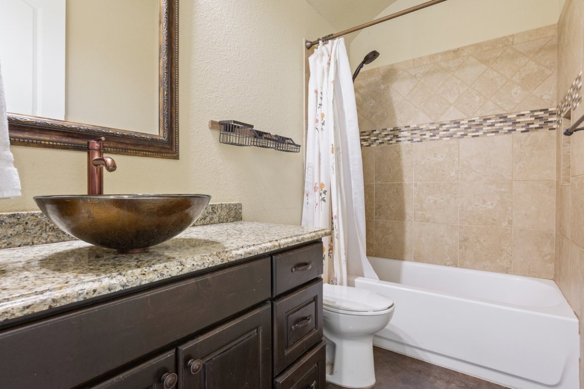 320 Ridge View Drive Georgetown, TX 78628 - Photo 14 of 31 a bathroom with a granite countertop sink toilet and shower