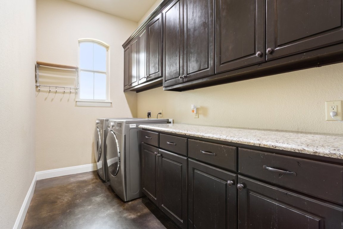 320 Ridge View Drive Georgetown, TX 78628 - Photo 17 of 31 a utility room with granite countertop cabinets and washer