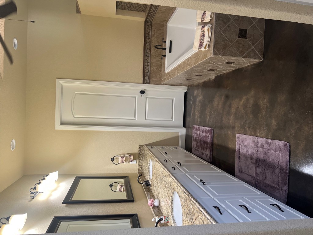 320 Ridge View Drive Georgetown, TX 78628 - Photo 27 of 31 a spacious bathroom with a granite countertop sink and a mirror