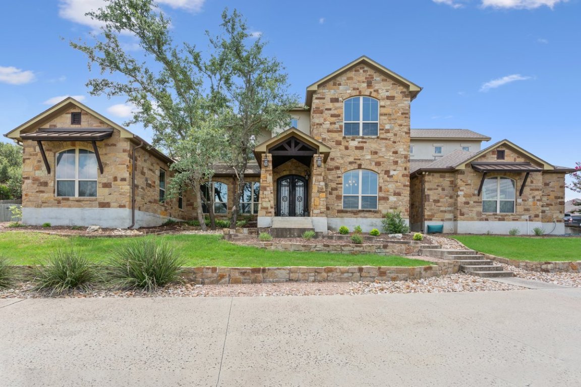 320 Ridge View Drive Georgetown, TX 78628 - Photo 2 of 31 a front view of a house with a garden and trees