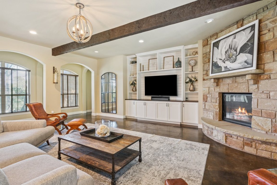 320 Ridge View Drive Georgetown, TX 78628 - Photo 5 of 31 a living room with furniture a flat screen tv and a fireplace