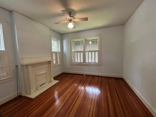 wooden floor in an empty room with a window