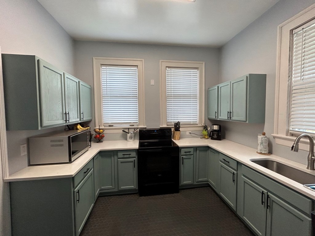 1192 Munro Avenue Columbus, GA 31906 - Photo 6 of 15 a kitchen with a sink stove and cabinets