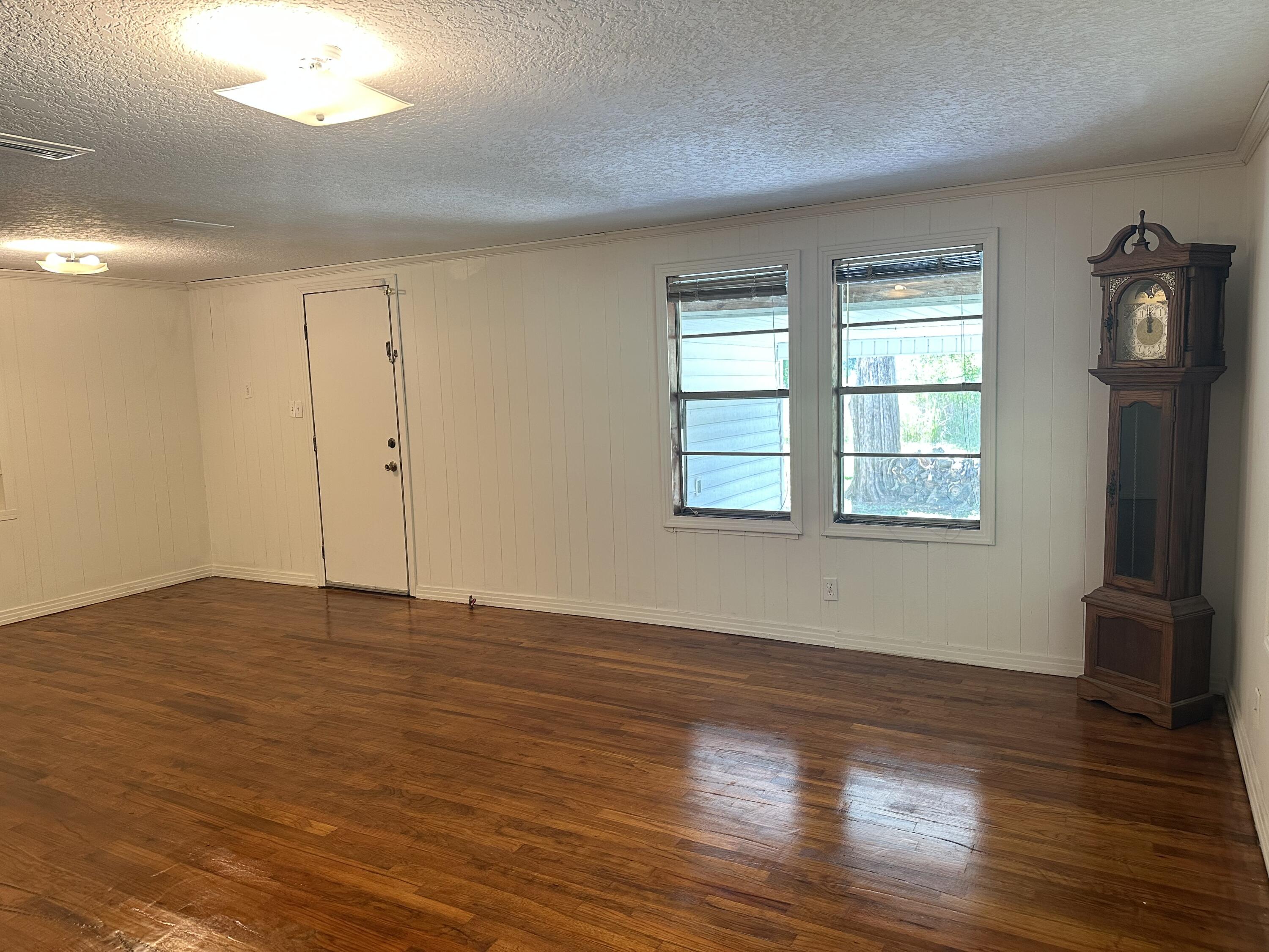 1875 Hathaway Johnson Road Baker, FL 32531 - Photo 13 of 40 a view of an empty room with wooden floor and a window