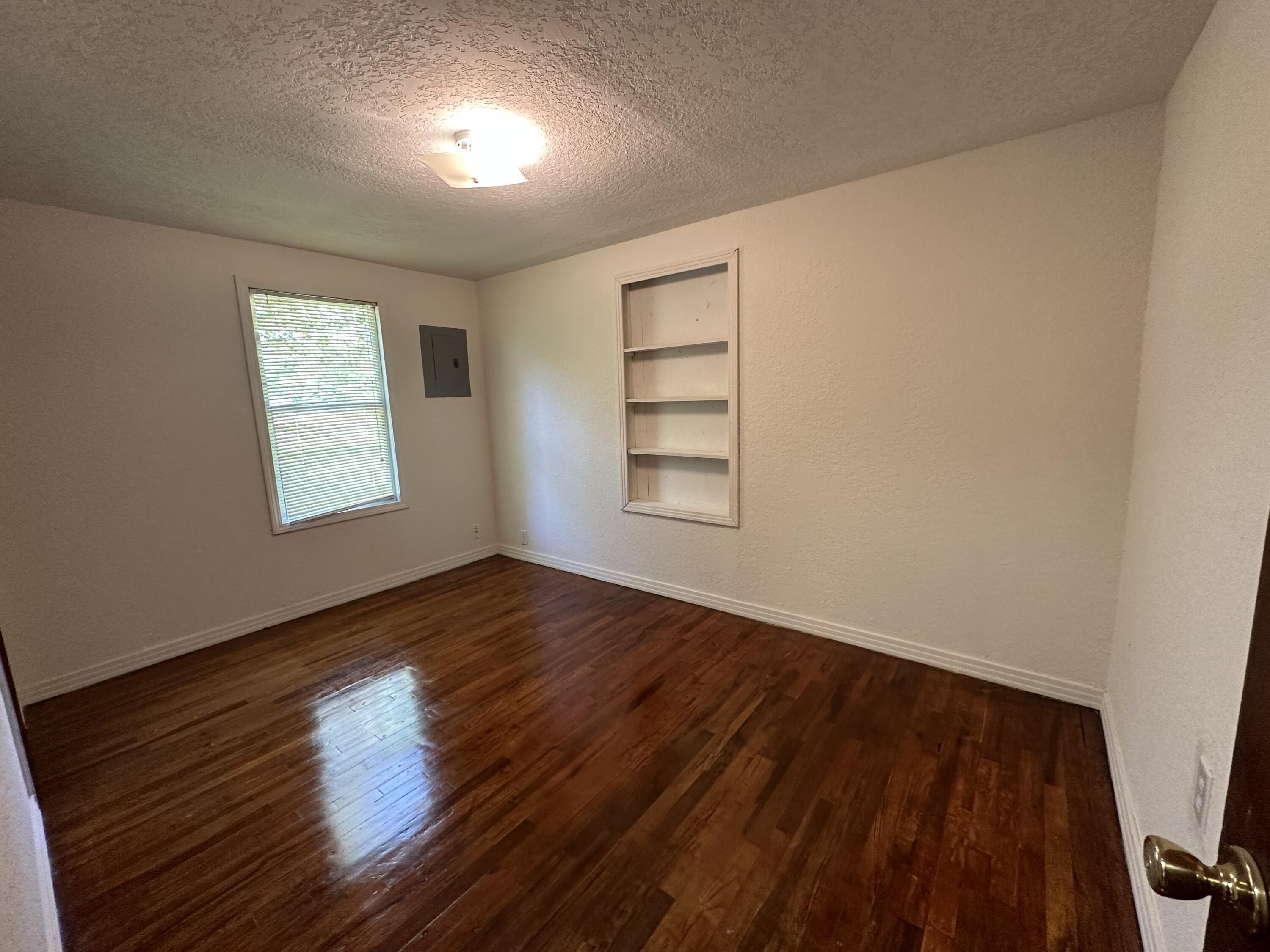 1875 Hathaway Johnson Road Baker, FL 32531 - Photo 14 of 40 wooden floor in an empty room with a window