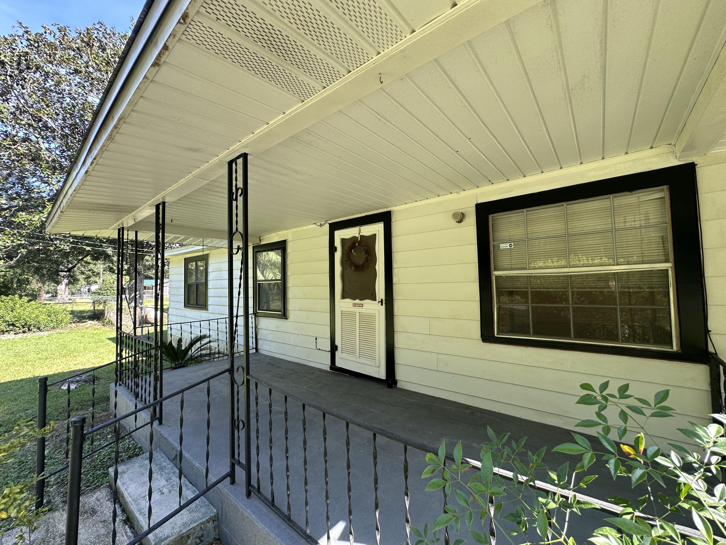 1875 Hathaway Johnson Road Baker, FL 32531 - Photo 2 of 40 a view of a house with a porch