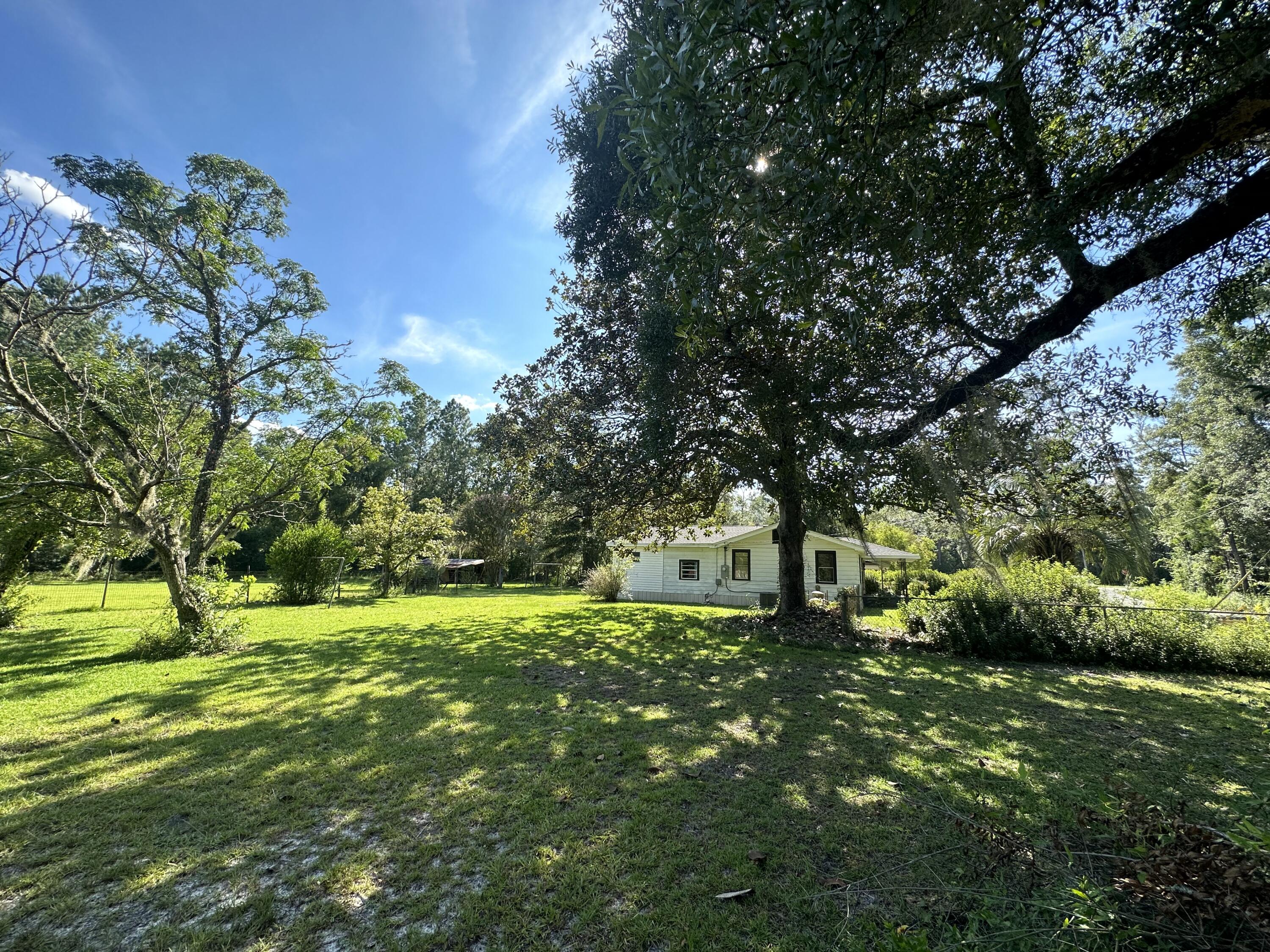 1875 Hathaway Johnson Road Baker, FL 32531 - Photo 24 of 40 a big yard with lots of green space and trees all around